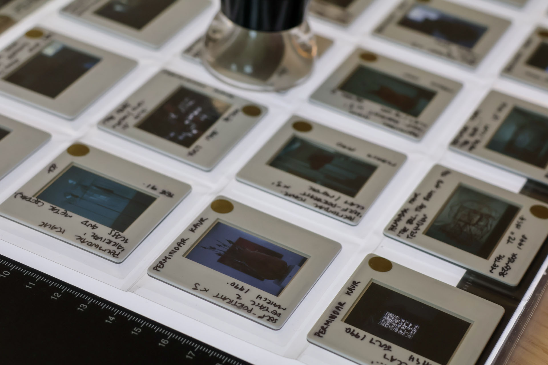 close-up of small slides of works in the Womens' Art Library on a backlit tablet