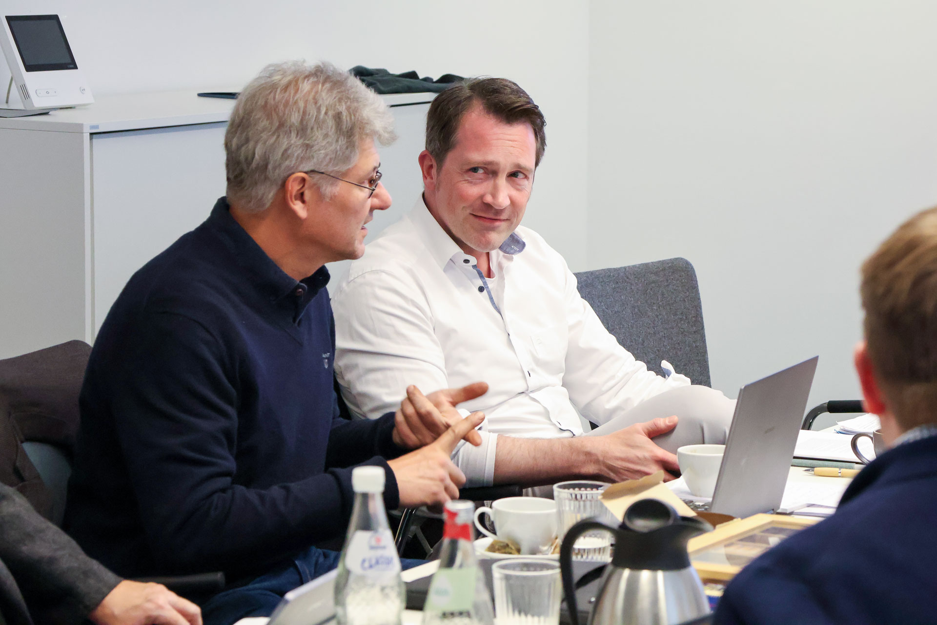 photo from the workshop 'Editing Journal Literature', two participants sitting at a table, one speaking