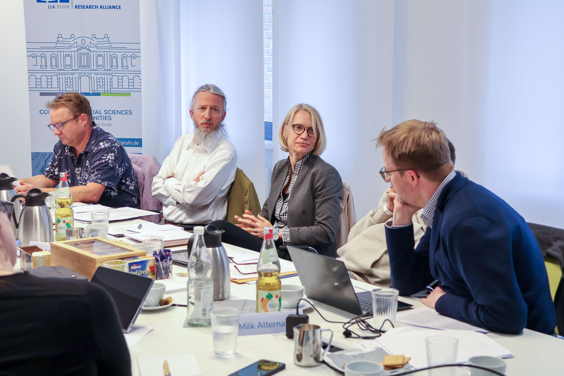 photo from the workshop 'Editing Journal Literature', participants sitting around a table, one speaking