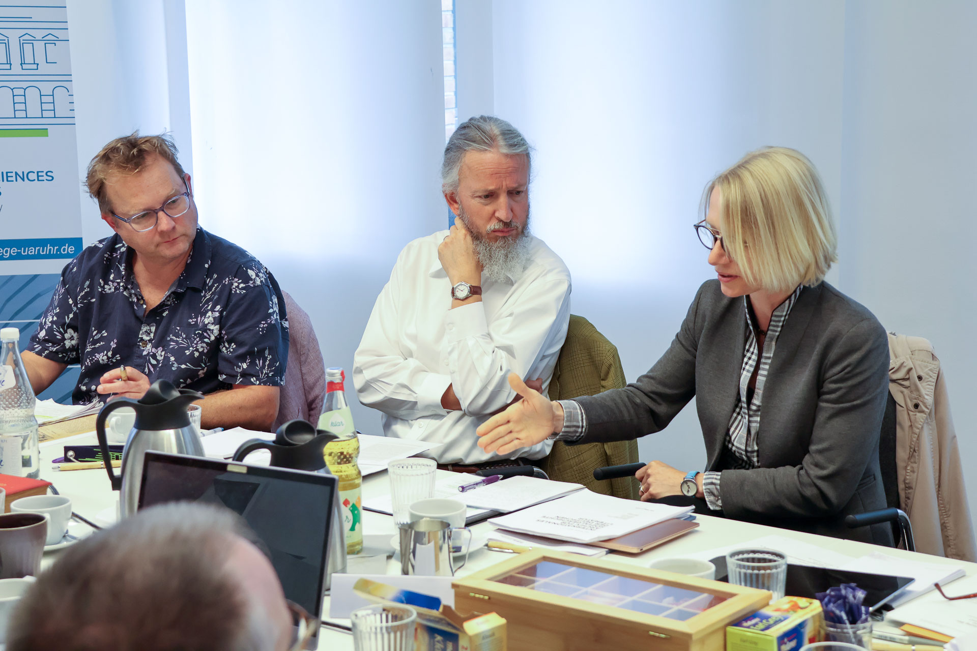 photo from the workshop 'Editing Journal Literature', participants sitting around a table, one speaking