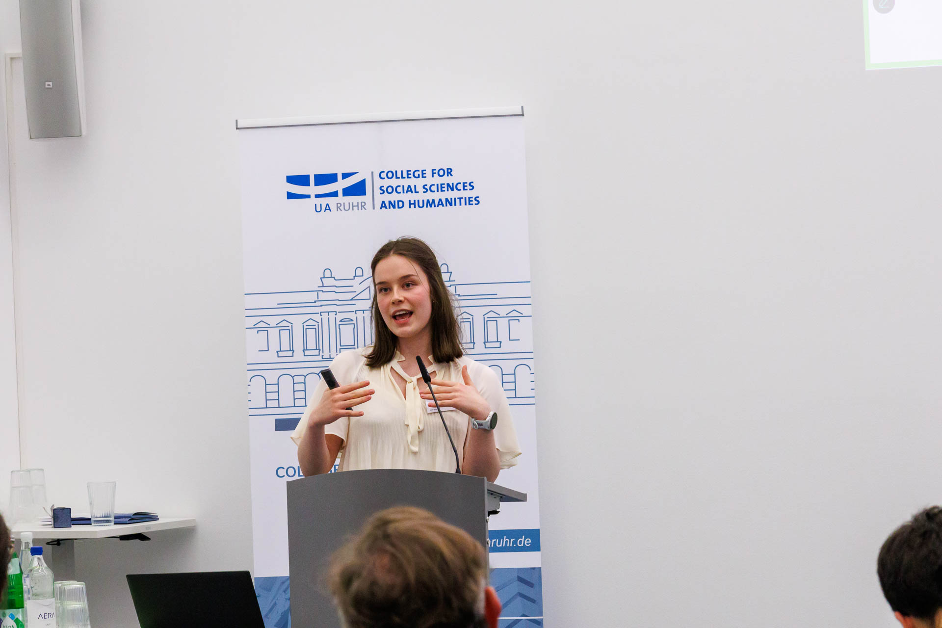 photo from the conference, speaker addressing the audience