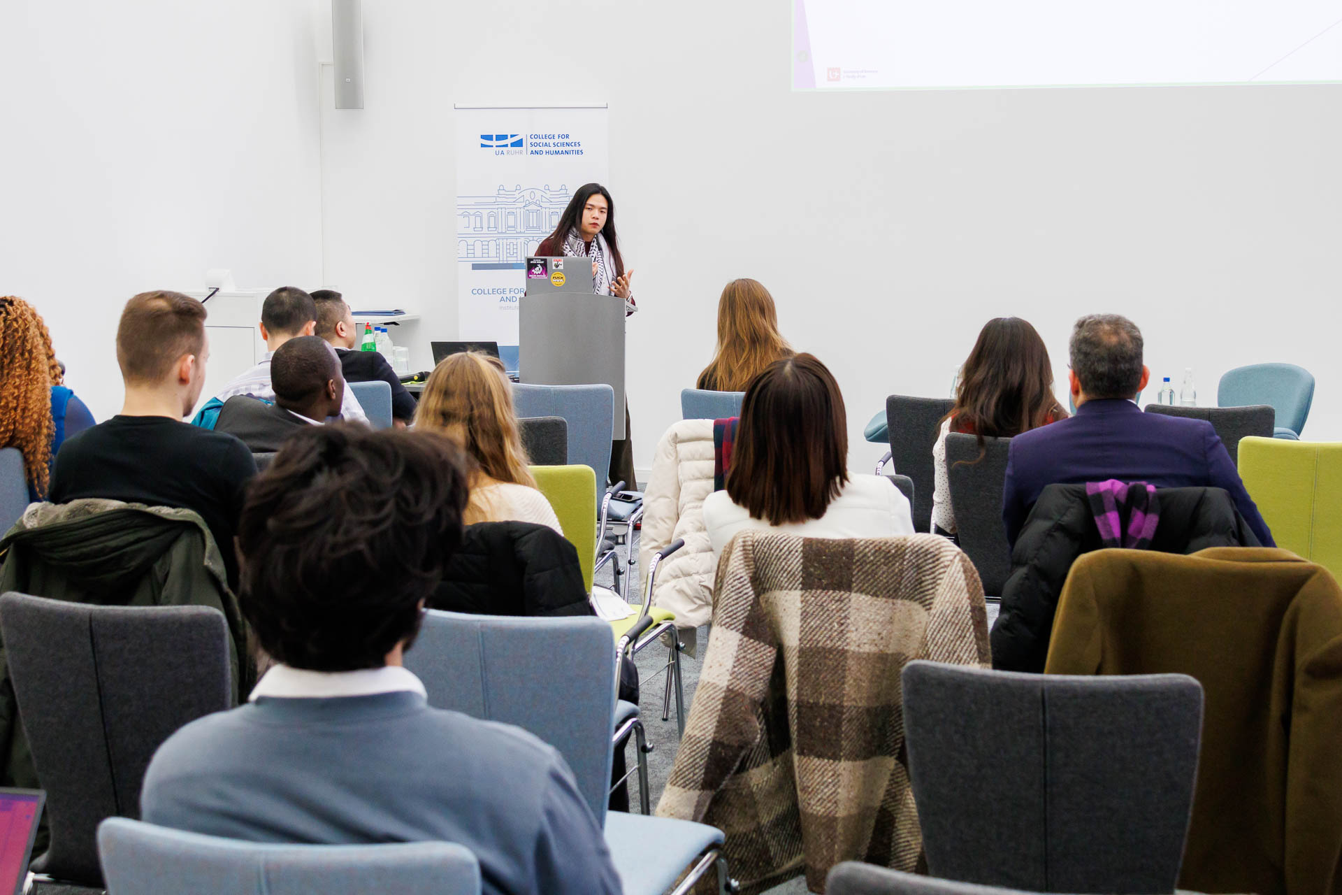 photo from the conference, speaker addressing the audience