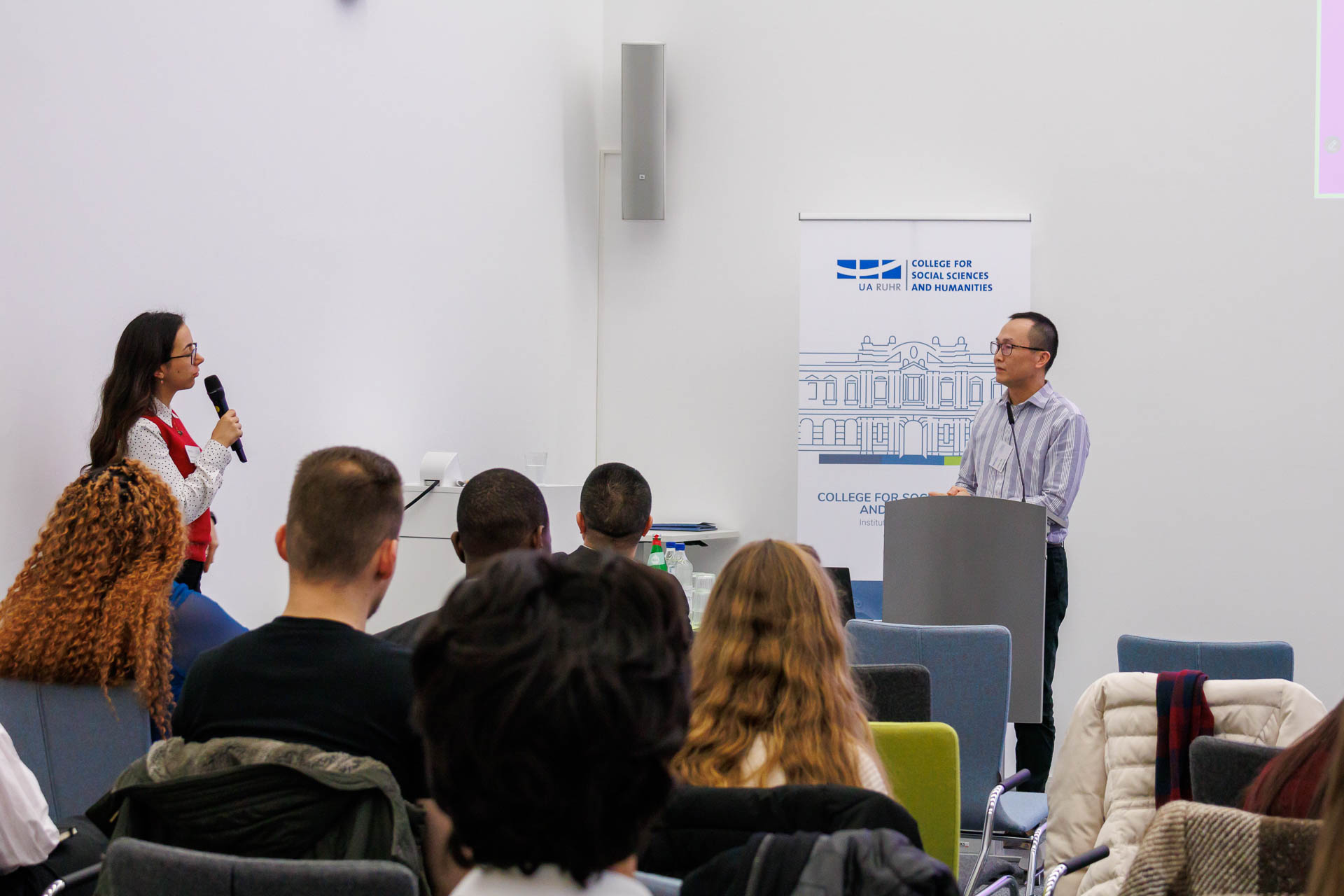 photo from the conference, panel moderator and speaker