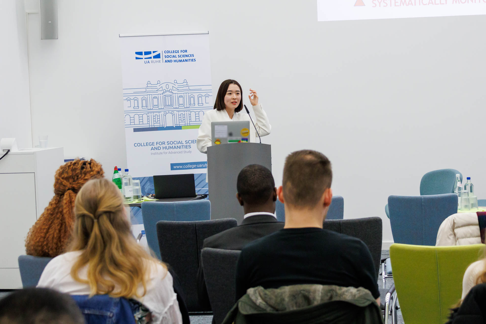 photo from the conference, speaker addressing the audience