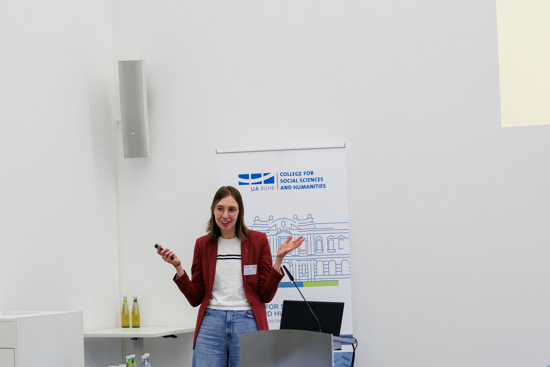 photo from the workshop 'Ethnic-Racial Socialisation', a speaker standing at a speaker's desk, gesturing