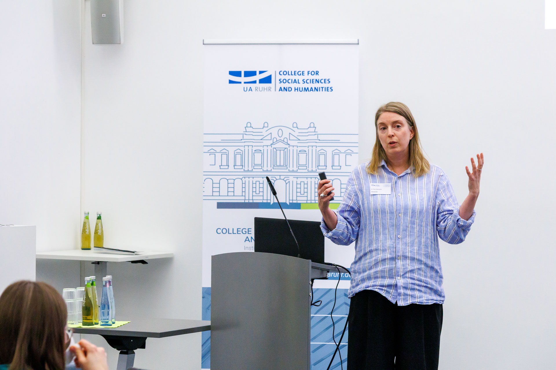 photo from the workshop 'Ethnic-Racial Socialisation', a speaker standing at a speaker's desk, gesturing