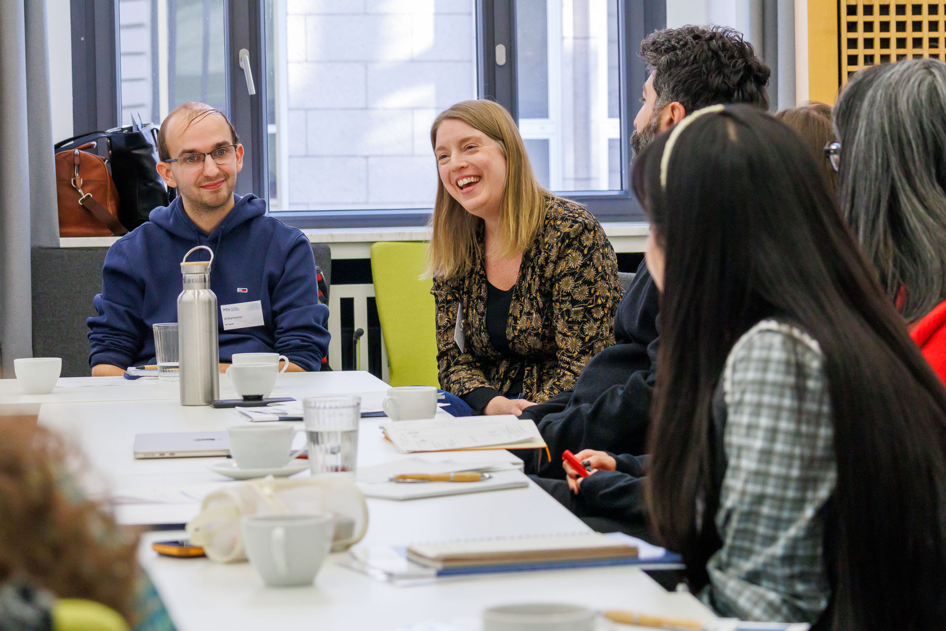 photo from the workshop 'Ethnic-Racial Socialisation', participants talking to each other at a large table
