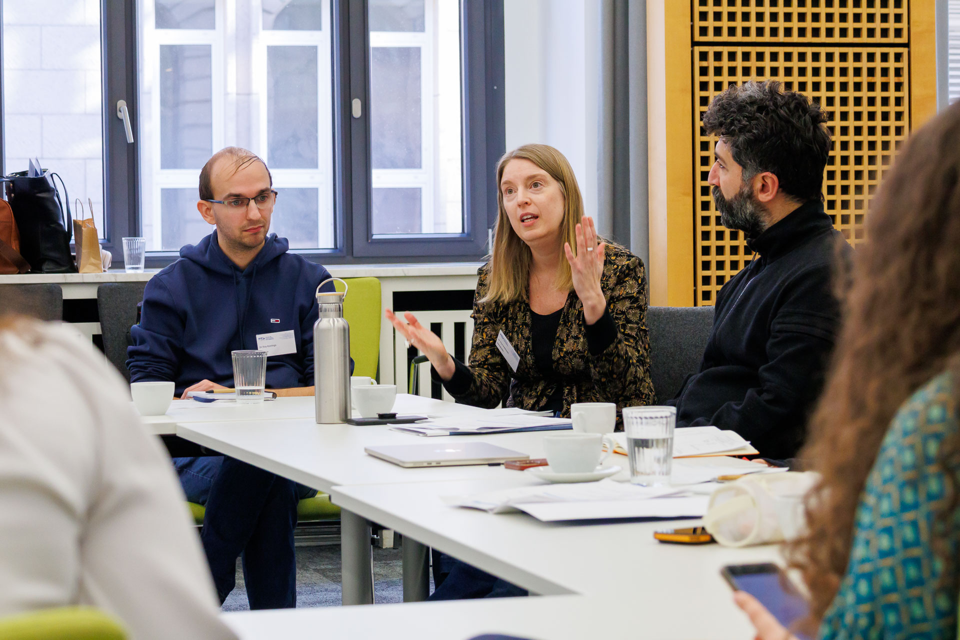 photo from the workshop 'Ethnic-Racial Socialisation', participants talking to each other at a large table