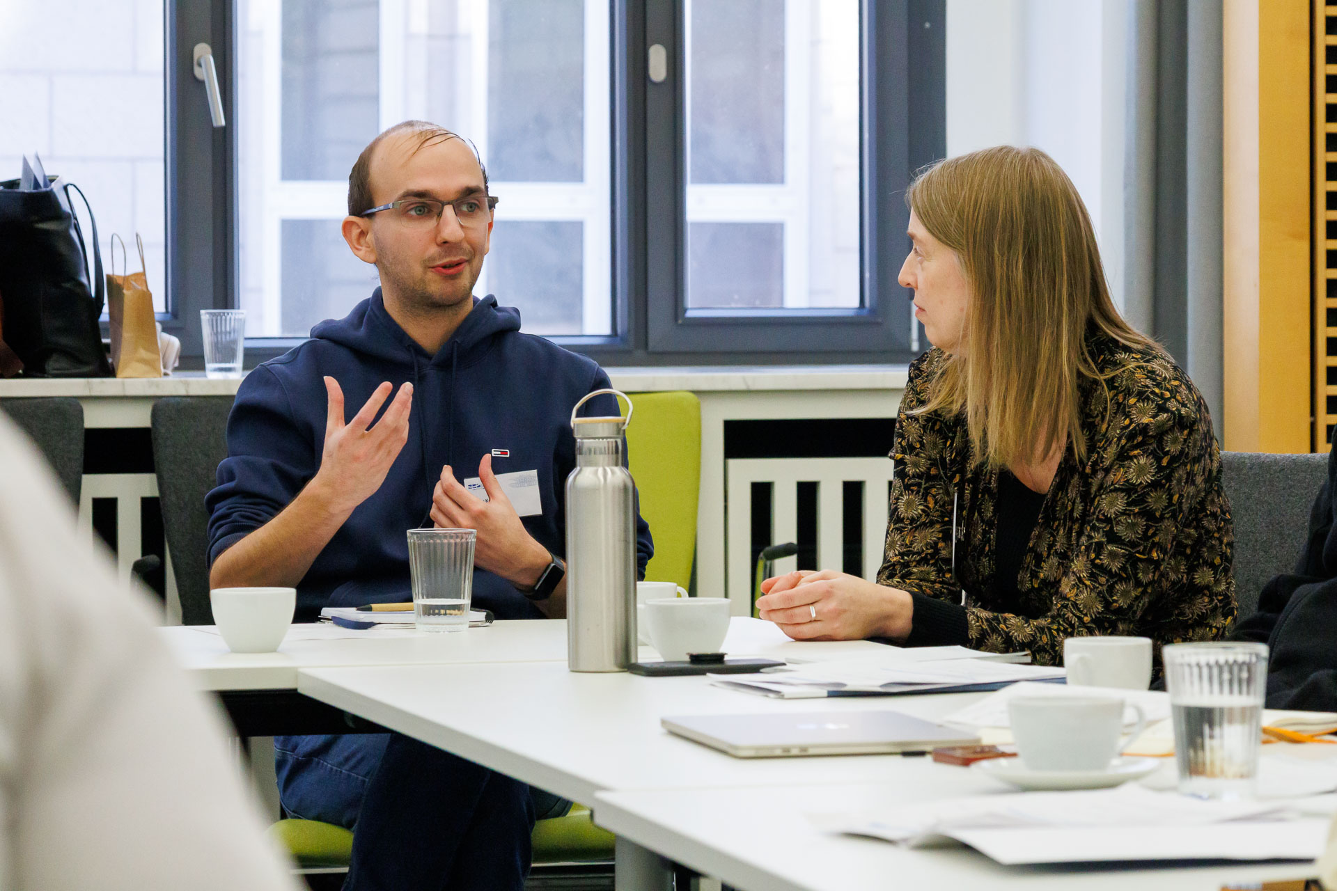 photo from the workshop 'Ethnic-Racial Socialisation', participants talking to each other at a large table