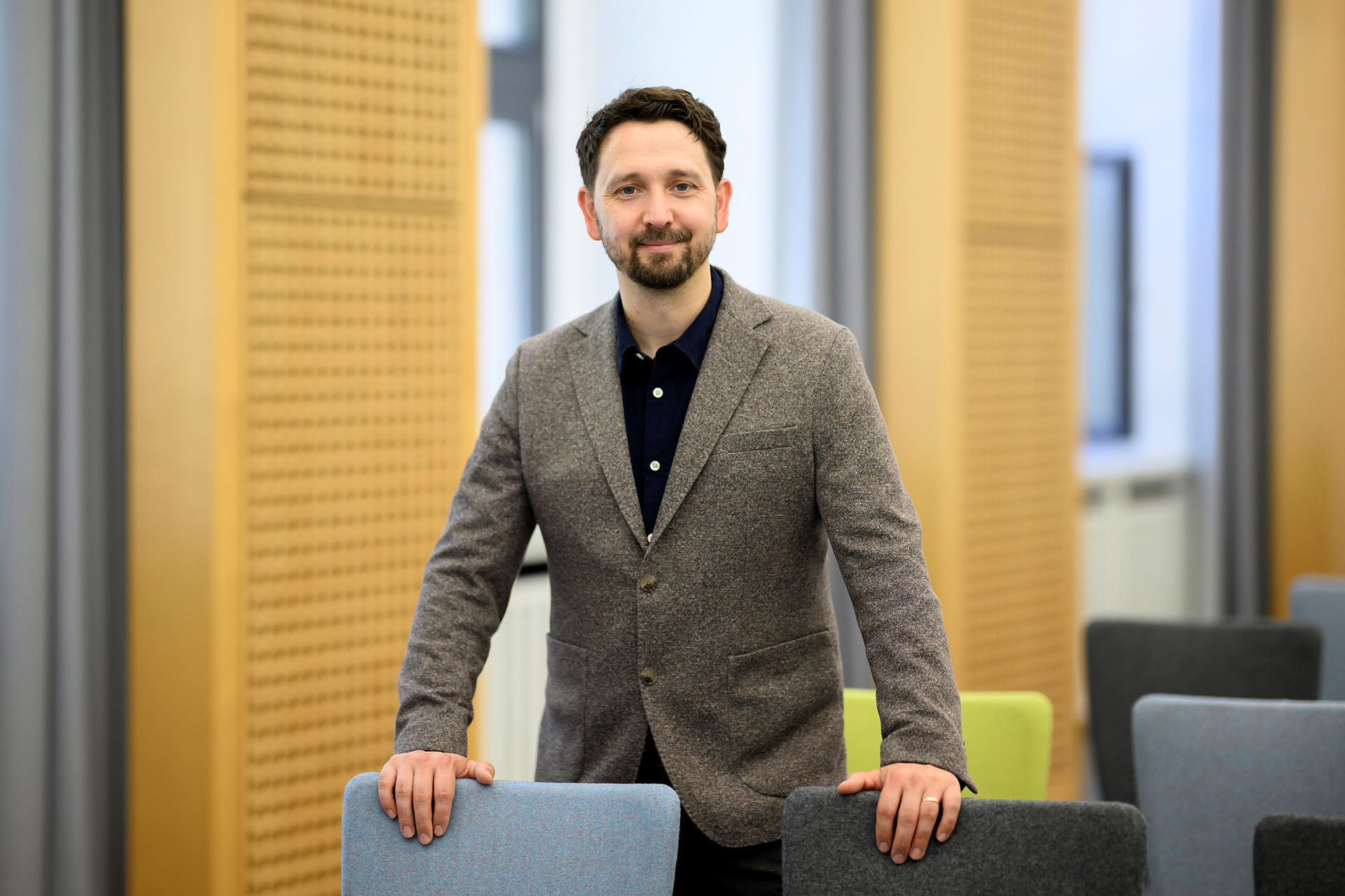 photo of Florian Fastenrath standing in the conference hall of the College
